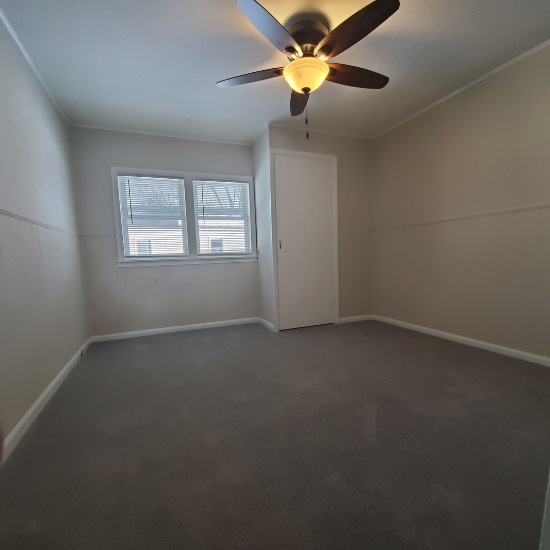 6020 Hickory Street Harvard, IL 60033 - Photo 8 of 17 an empty room with a window and a fan