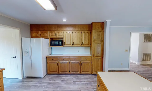 a view of a kitchen with a sink and a fireplace