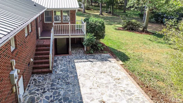 a view of a yard with plants and wooden fence