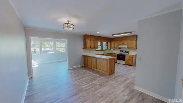 a view of kitchen with sink and wooden floor