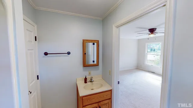 a bathroom with a sink vanity and mirror
