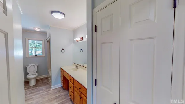 a spacious bathroom with a granite countertop sink a toilet and shower
