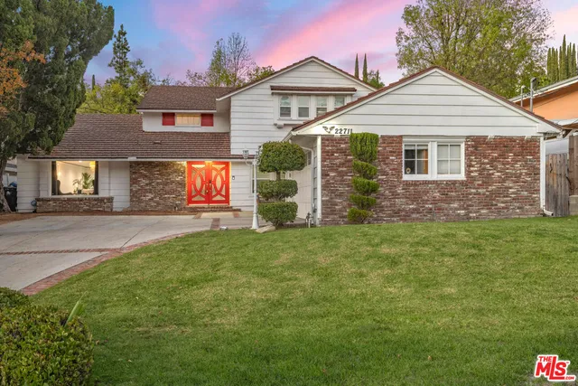 a view of a backyard with swimming pool and furniture