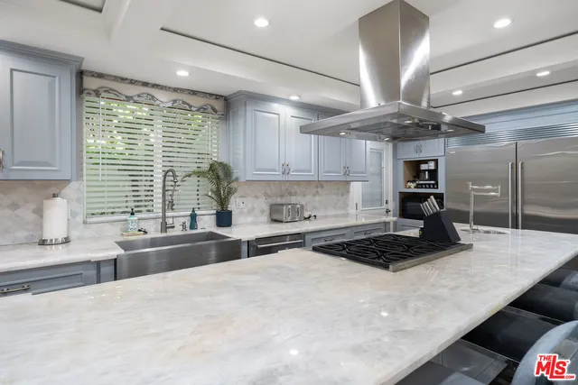 a spacious bathroom with a granite countertop sink and a mirror