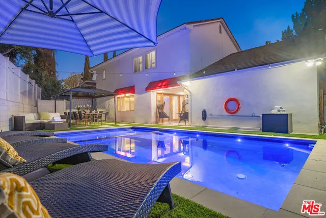 a kitchen with stainless steel appliances granite countertop a sink and wooden cabinets
