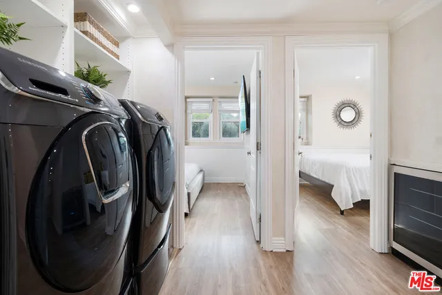 a large bed sitting in a bedroom next to a window