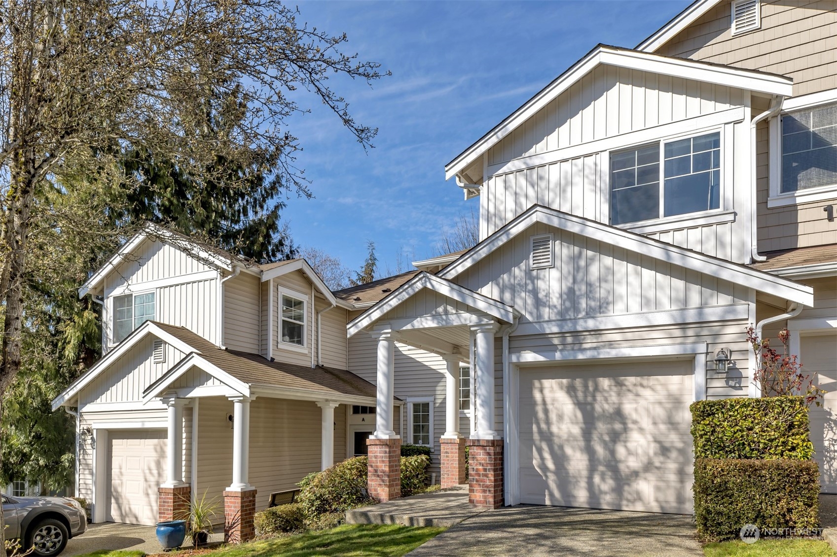 108 South 49th Street, Unit B Renton, WA 98055 - Photo 1 of 24 a view of a white house with large windows and a table and chairs