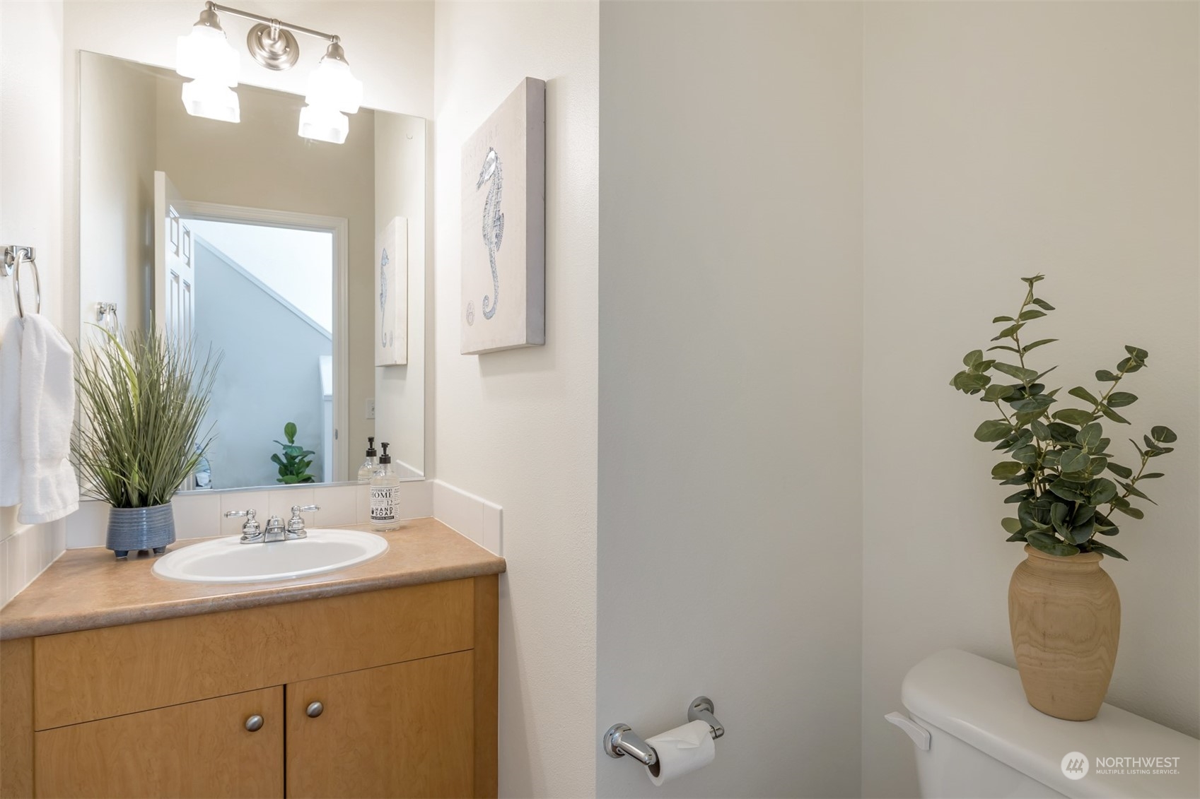 108 South 49th Street, Unit B Renton, WA 98055 - Photo 11 of 24 a bathroom with a sink a toilet and a mirror