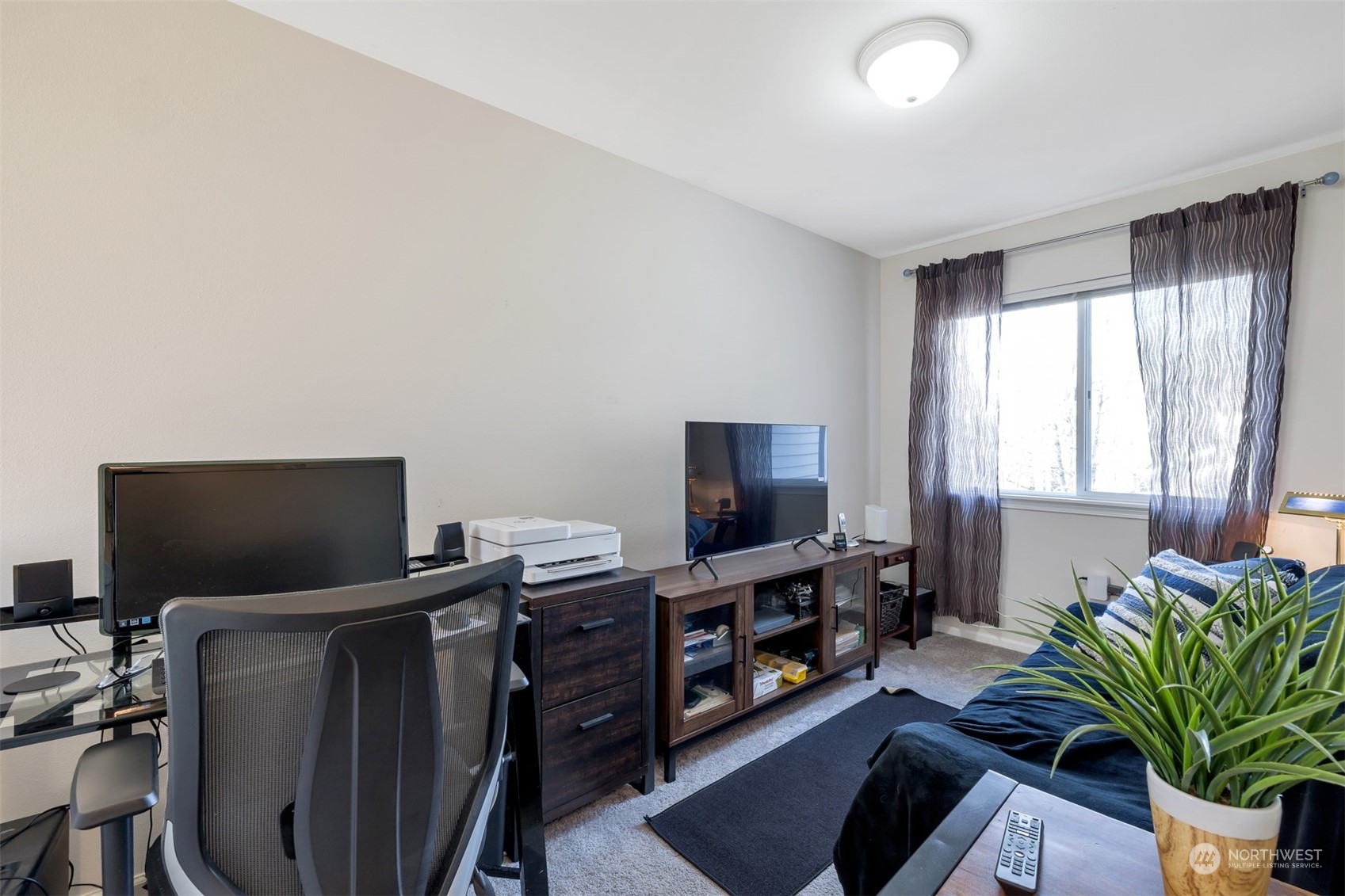108 South 49th Street, Unit B Renton, WA 98055 - Photo 12 of 24 a living room with furniture and a flat screen tv