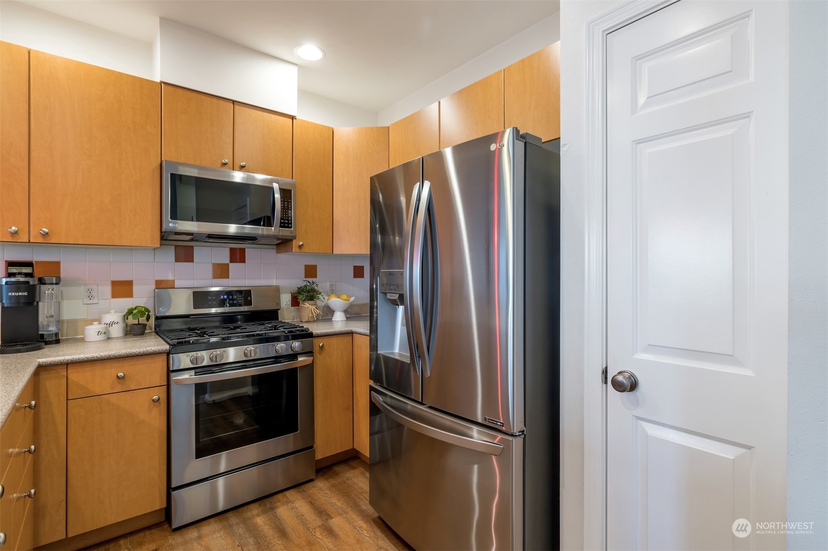 108 South 49th Street, Unit B Renton, WA 98055 - Photo 8 of 24 a kitchen with stainless steel appliances a refrigerator stove and microwave