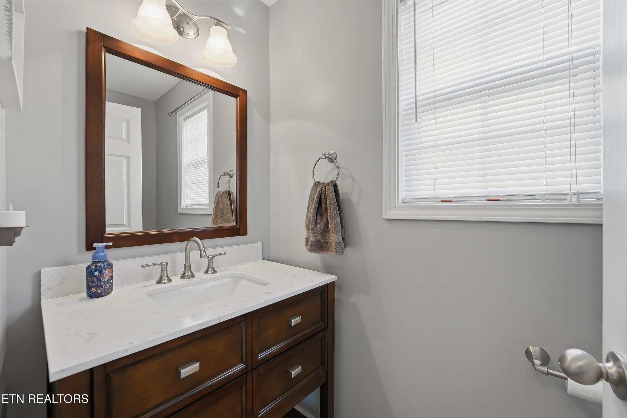 8508 Bowsong Lane Powell, TN 37849 - Photo 10 of 28 a bathroom with a sink vanity and a mirror