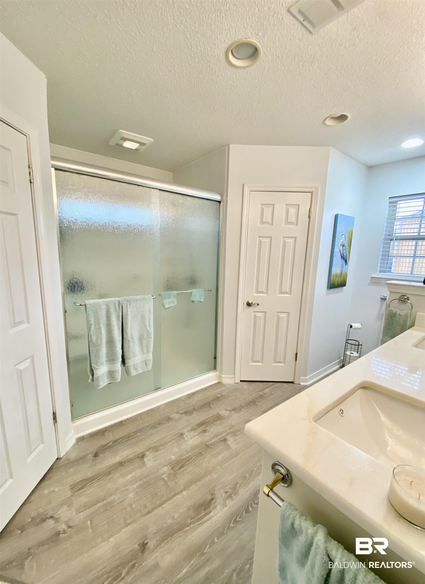 2872 Avenida Alberto Lillian, AL 36549 - Photo 21 of 31 Bathroom with hardwood / wood-style floors, vanity, a textured ceiling, and walk in shower