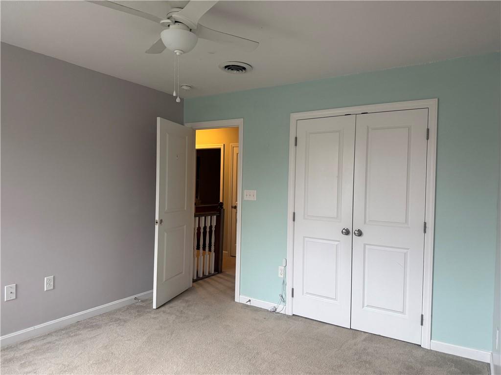 305 Garden Court Gibsonia, PA 15044 - Photo 15 of 28 an empty room with closet and a ceiling fan