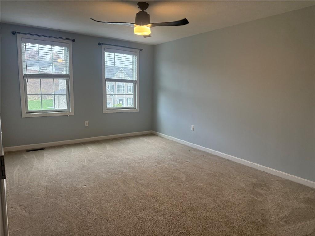 305 Garden Court Gibsonia, PA 15044 - Photo 21 of 28 an empty room with a window and chandelier fan