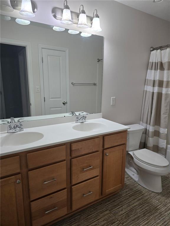 305 Garden Court Gibsonia, PA 15044 - Photo 26 of 28 a bathroom with a double vanity sink and a toilet