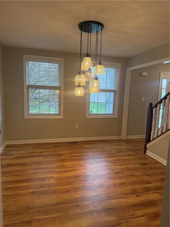305 Garden Court Gibsonia, PA 15044 - Photo 4 of 28 a view of an empty room with wooden floor and a window