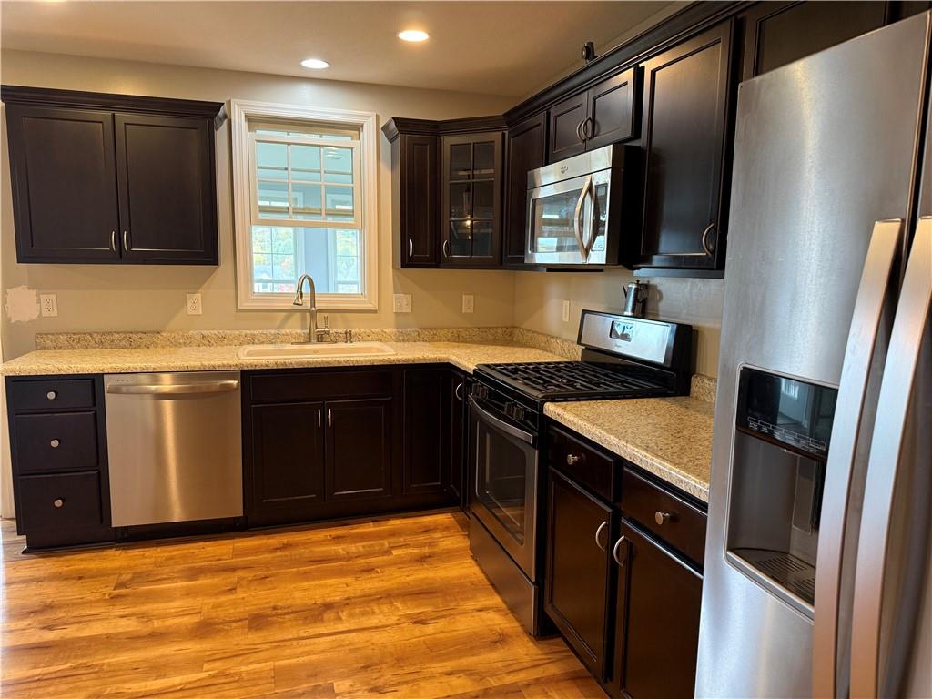 305 Garden Court Gibsonia, PA 15044 - Photo 7 of 28 a kitchen with stainless steel appliances granite countertop a sink stove and refrigerator