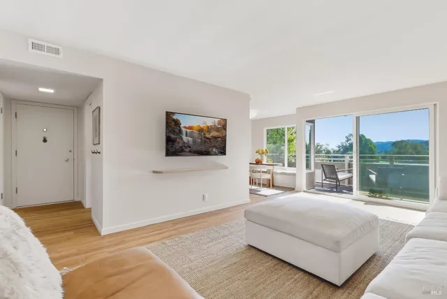 a living room with a large window and a flat screen tv