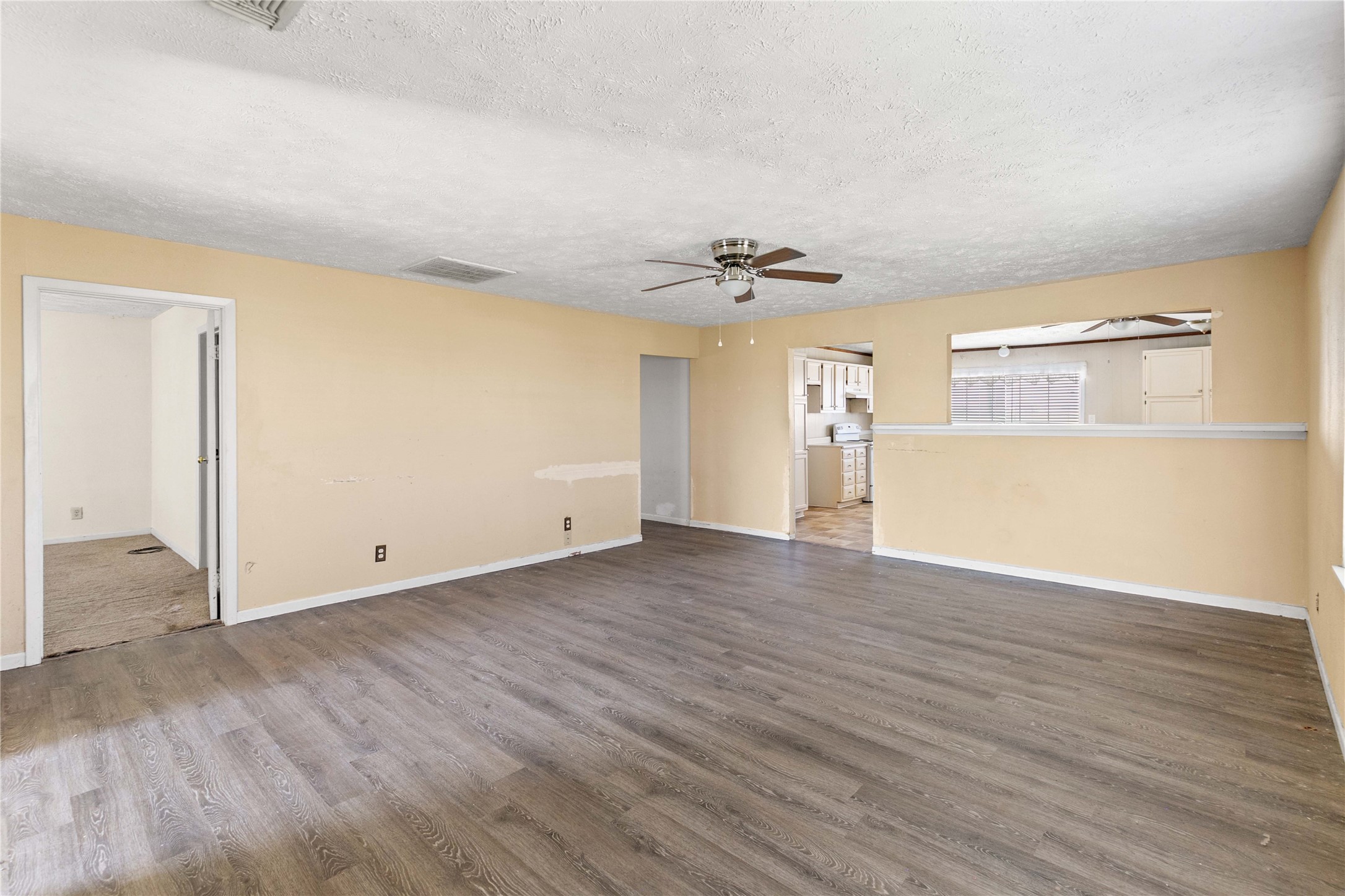 910 Monument Drive Surfside Beach, TX 77541 - Photo 12 of 29 wooden floor in an empty room with a window