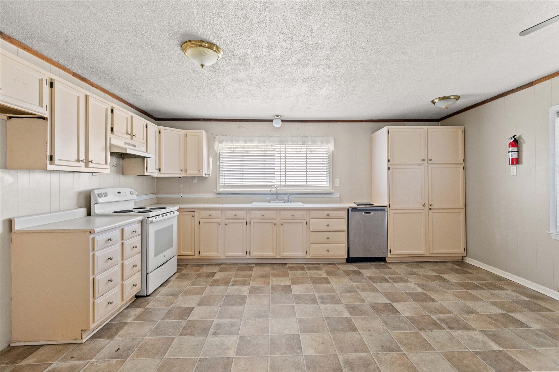 910 Monument Drive Surfside Beach, TX 77541 - Photo 13 of 29 a kitchen with a stove a sink and a refrigerator