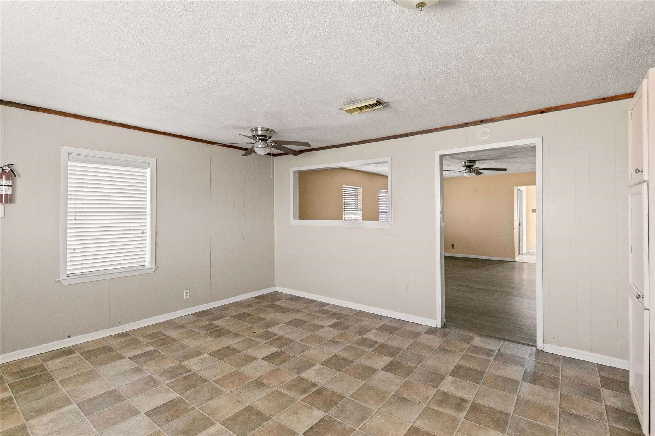 910 Monument Drive Surfside Beach, TX 77541 - Photo 15 of 29 a view of an empty room with wooden floor and a window