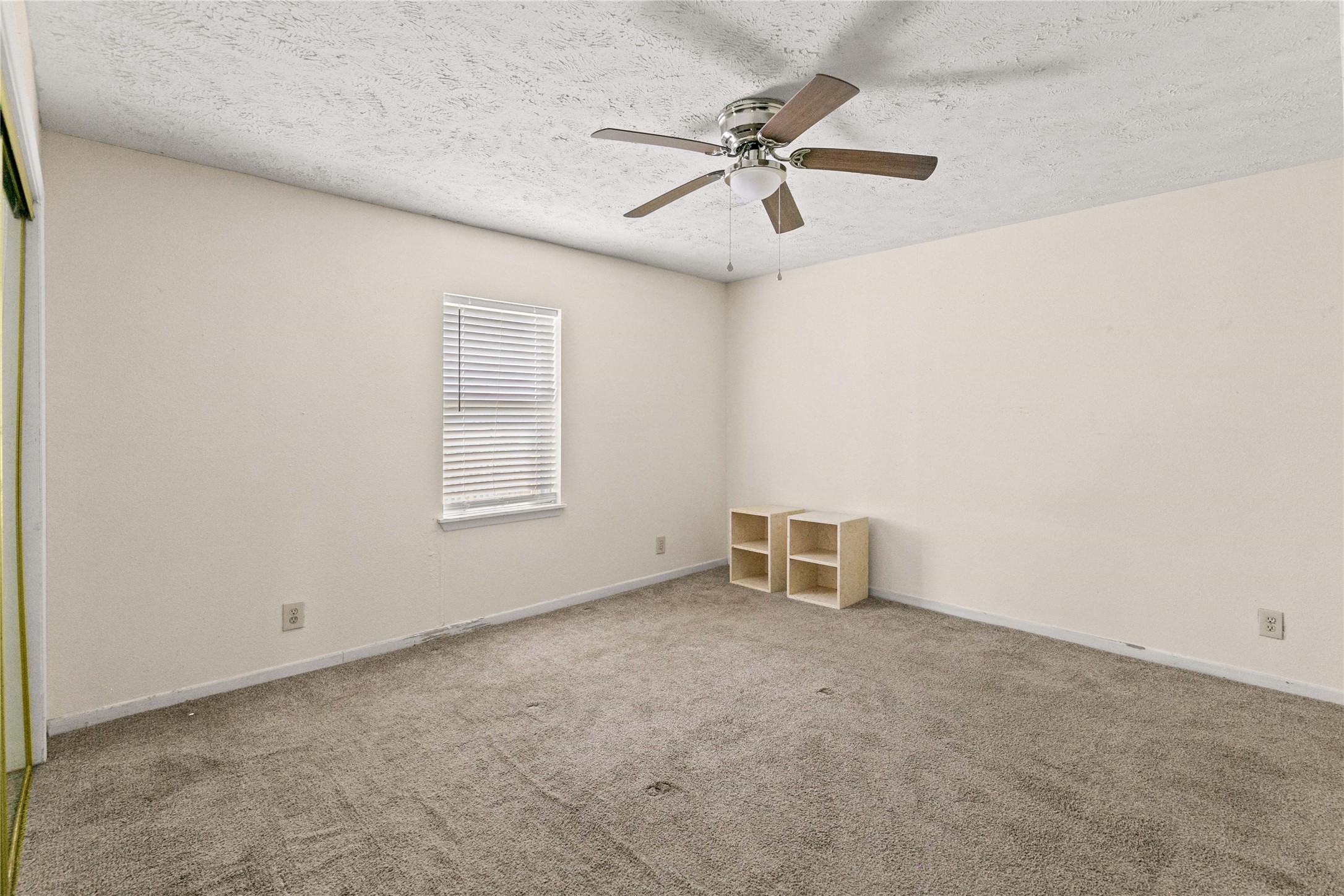 910 Monument Drive Surfside Beach, TX 77541 - Photo 16 of 29 an empty room with windows and fan