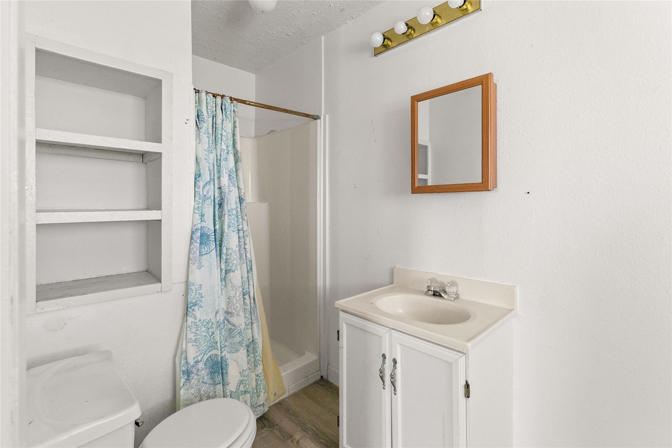 910 Monument Drive Surfside Beach, TX 77541 - Photo 22 of 29 a bathroom with a sink toilet and shower