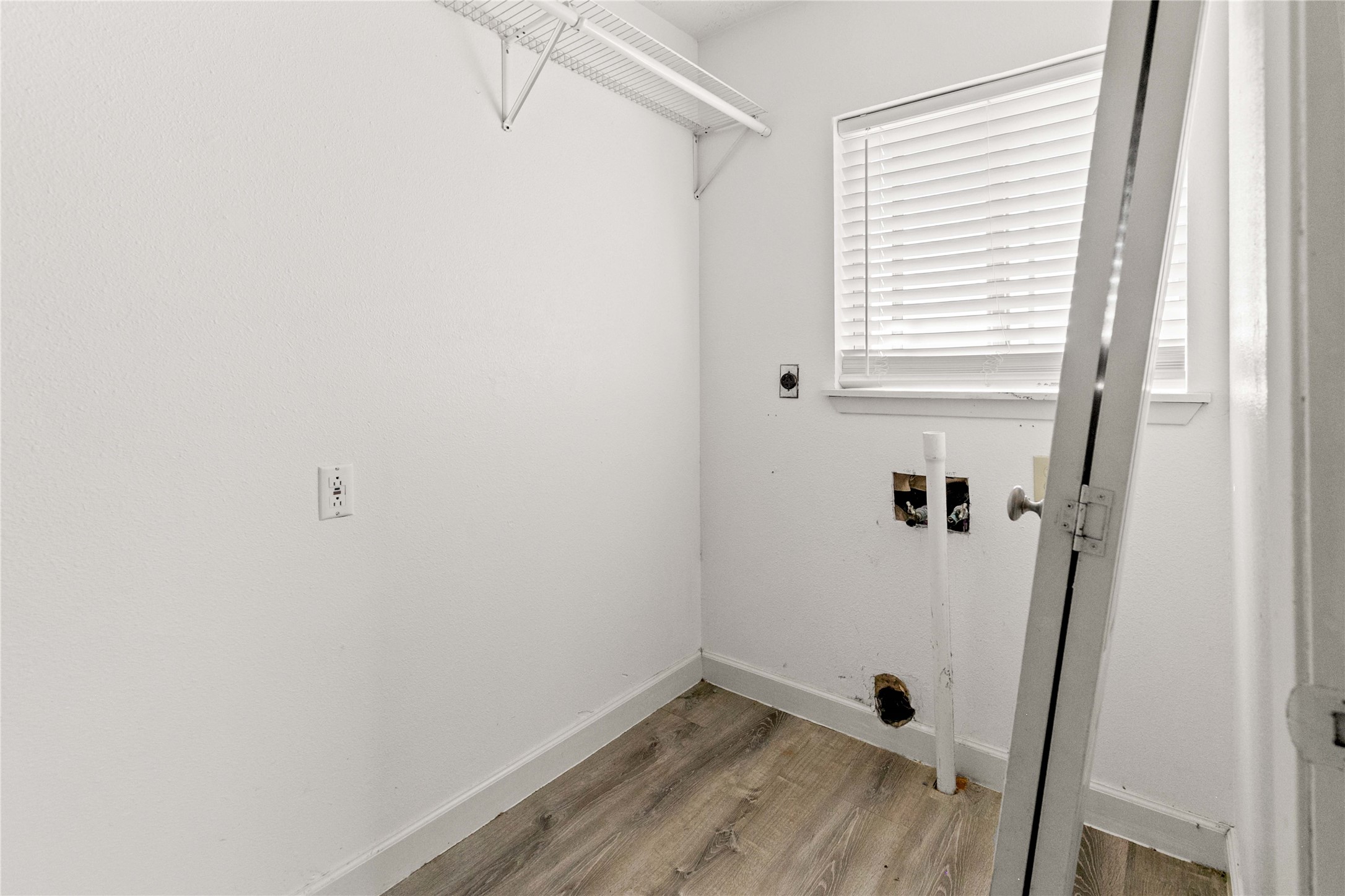 910 Monument Drive Surfside Beach, TX 77541 - Photo 23 of 29 a view of a room with wooden floor and a window