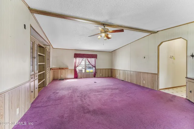 a view of a hallway with wooden shelves