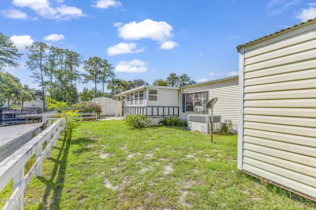 an aerial view of residential houses with outdoor space and street view