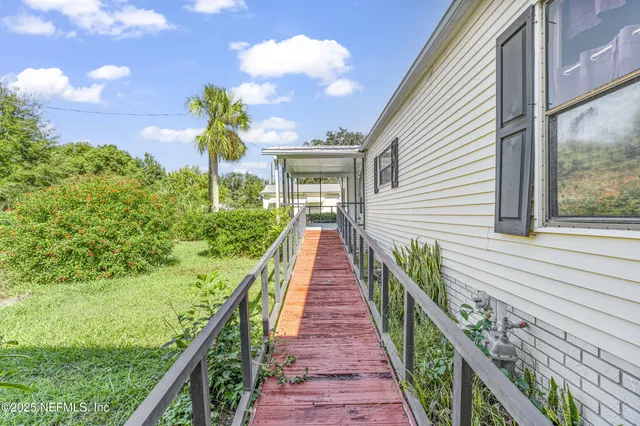a view of a room with balcony and large windows