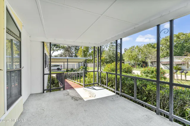 a view of a house with a yard and furniture