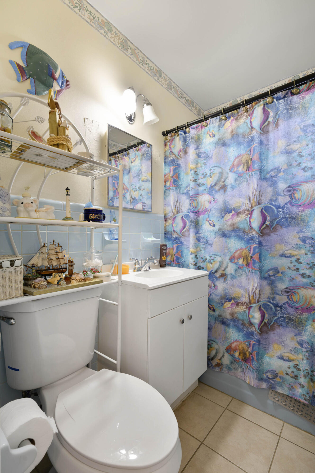 939 Bianca Drive Northeast Palm Bay, FL 32905 - Photo 19 of 26 a bathroom with a granite countertop toilet sink and mirror