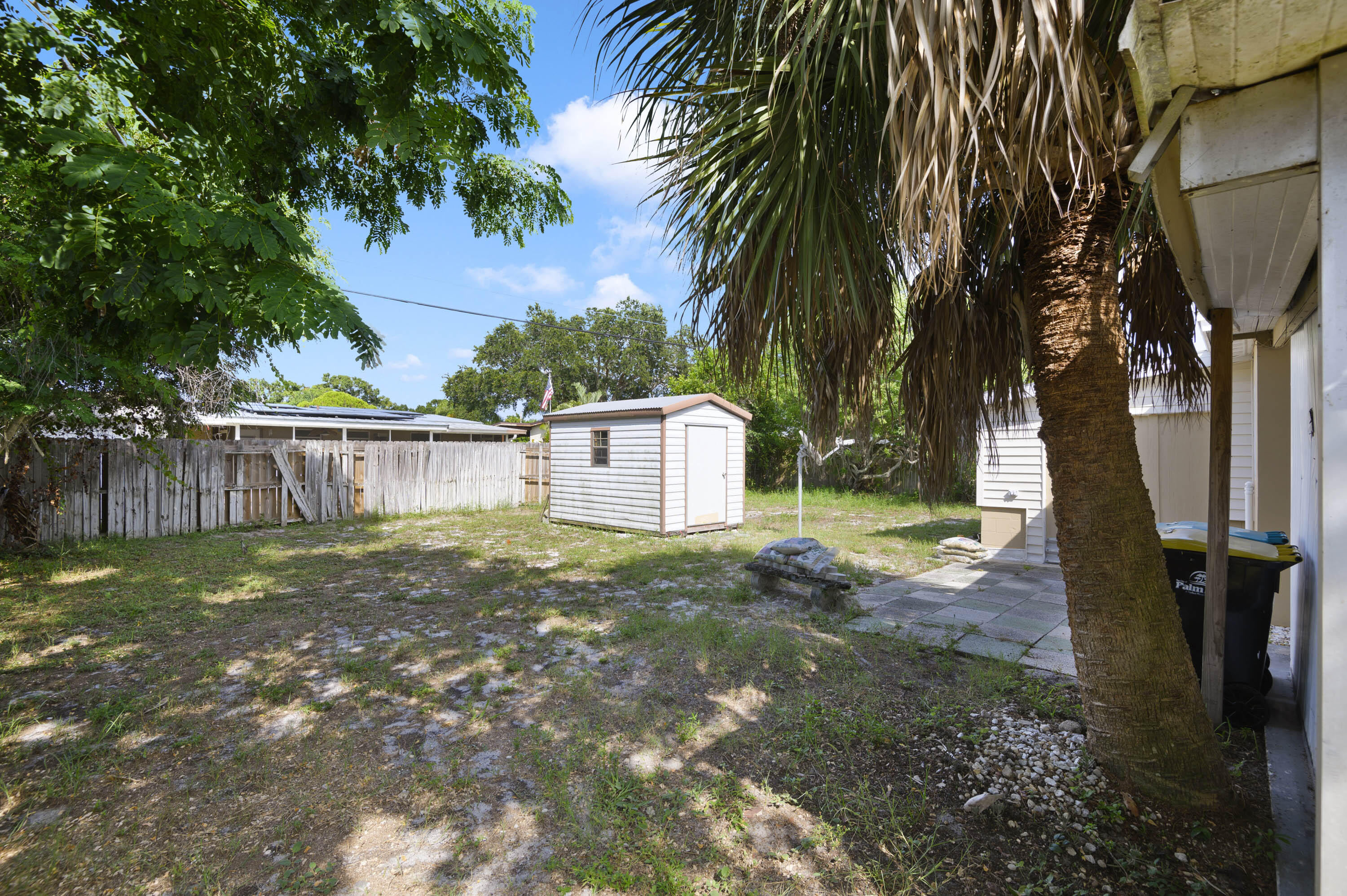 939 Bianca Drive Northeast Palm Bay, FL 32905 - Photo 20 of 26 a backyard of a house with a garden and outdoor seating