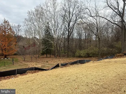 a view of a house with a yard covered with snow