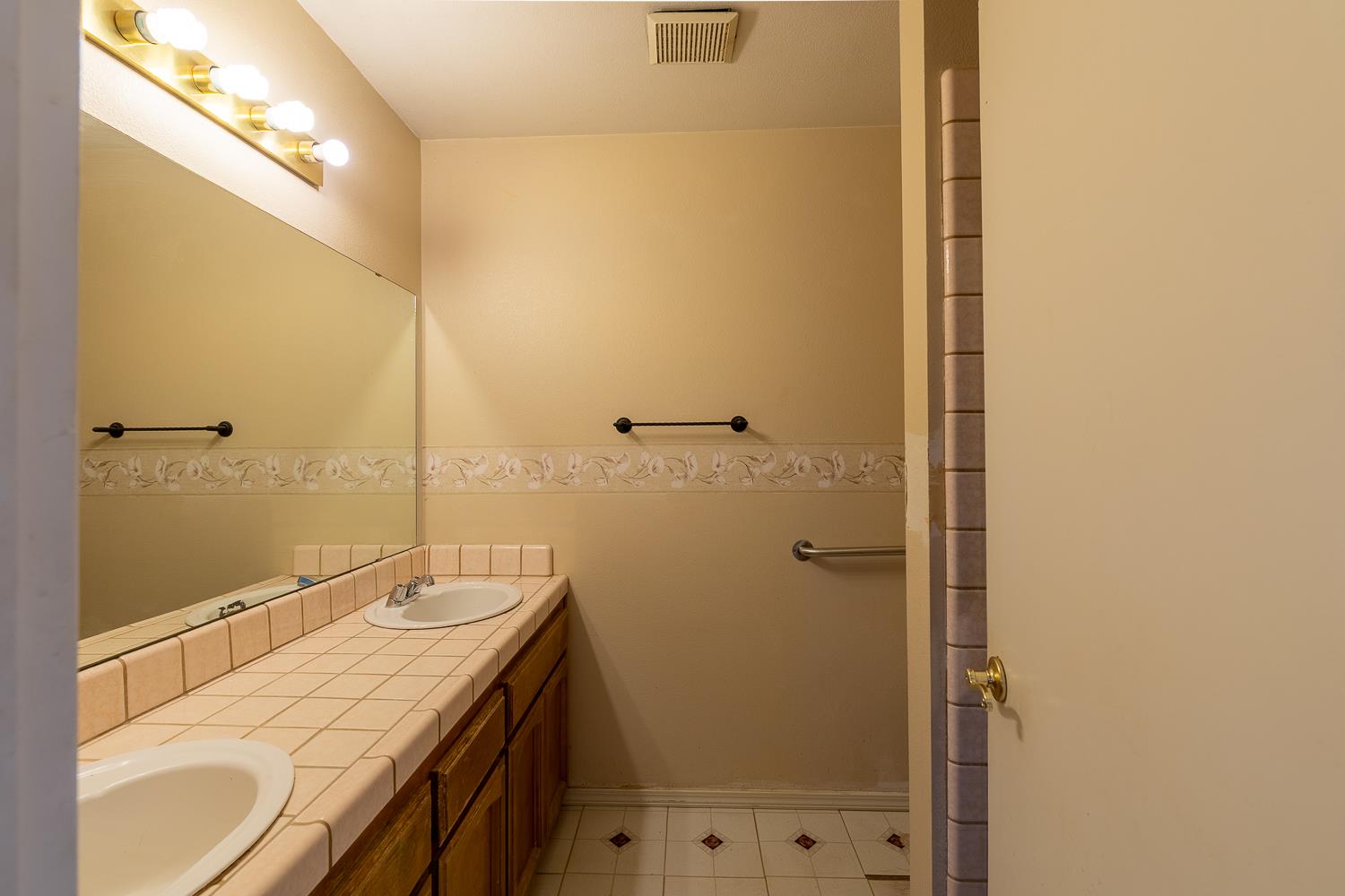 25199 Ave 18 Madera, CA 93638 - Photo 15 of 20 a bathroom with a granite countertop sink a mirror and a shower