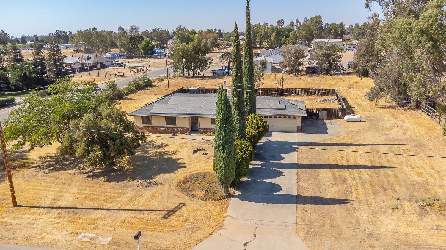 25199 Ave 18 Madera, CA 93638 - Photo 17 of 20 a view of a yard and front view of a house