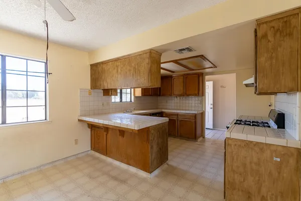 a kitchen that has a sink and a stove in it