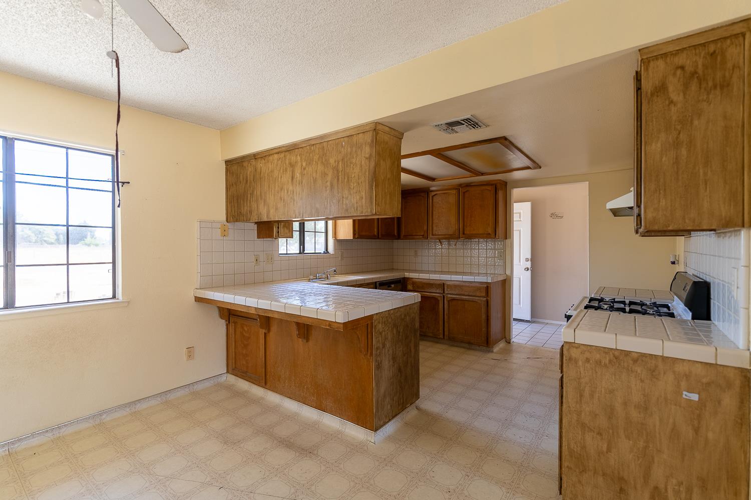 25199 Ave 18 Madera, CA 93638 - Photo 7 of 20 a kitchen that has a sink and a stove in it