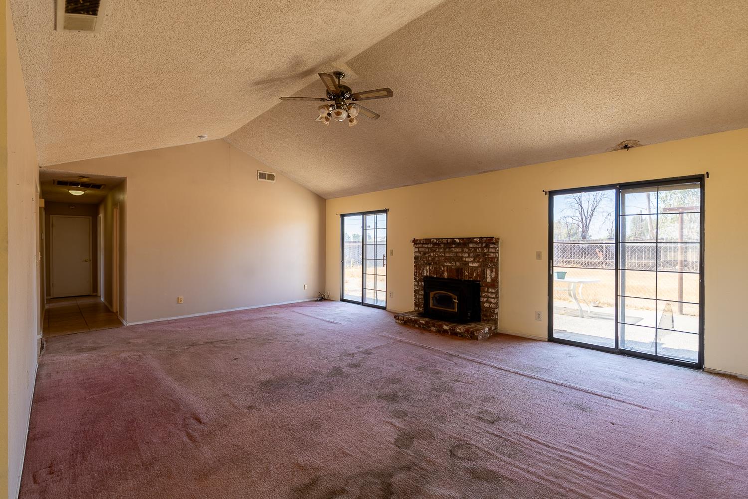 25199 Ave 18 Madera, CA 93638 - Photo 8 of 20 a view of an empty room with a fireplace and a window