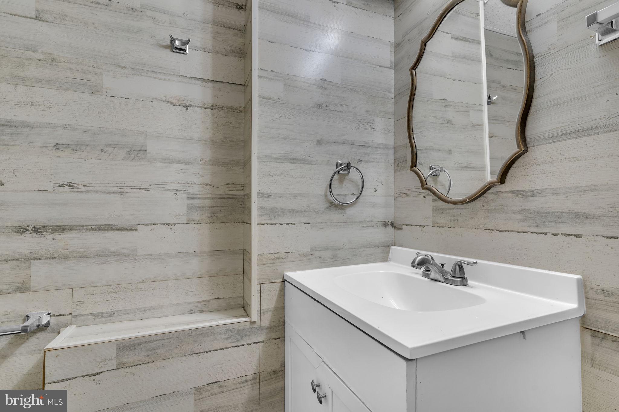 21705 Great Mills Lane, Unit C Lexington Park, MD 20653 - Photo 12 of 16 a bathroom with a sink and a mirror