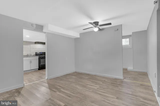 a view of a kitchen with a sink and a refrigerator