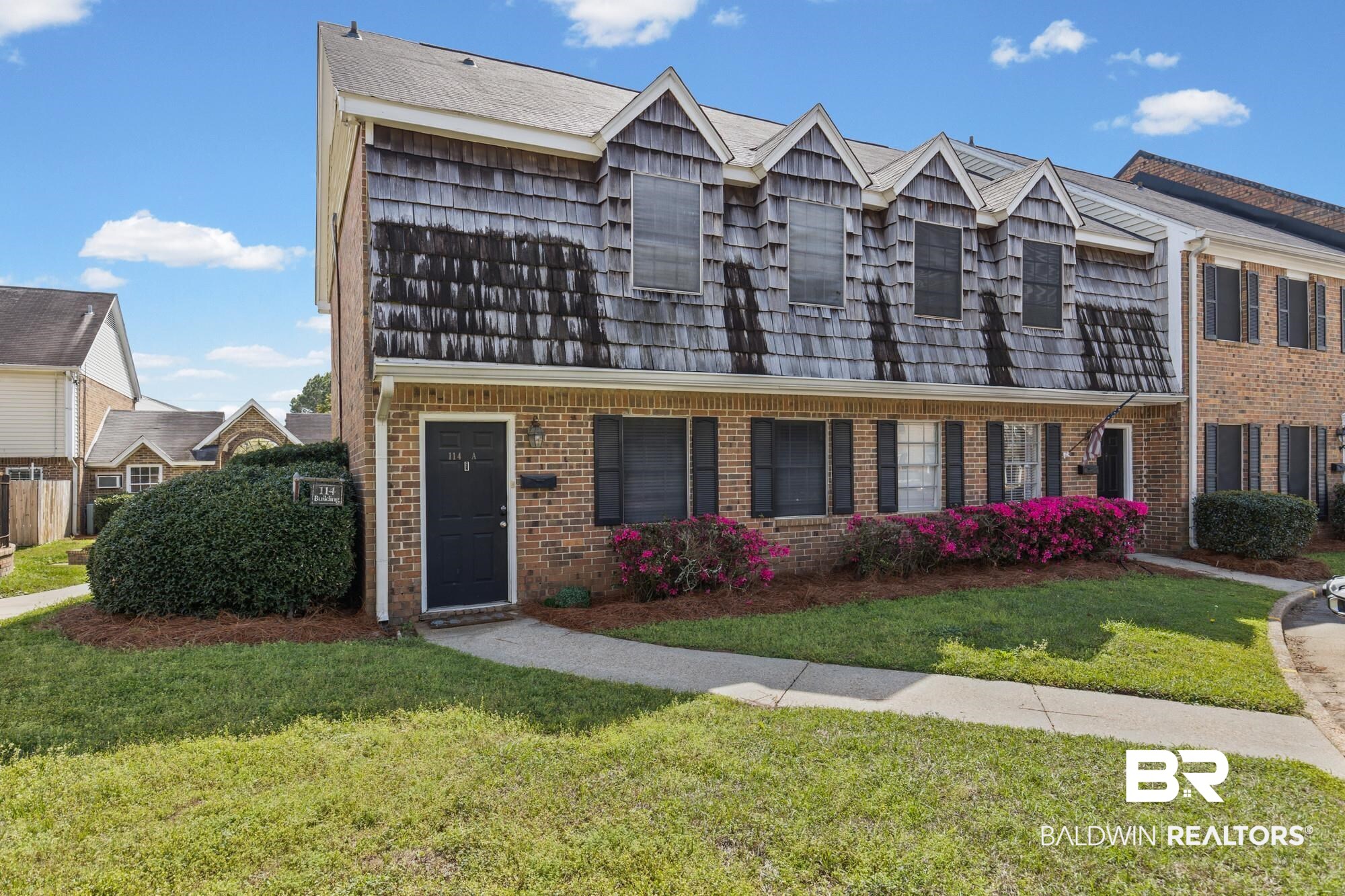 114 Du Rhu Drive, Unit A Mobile, AL 36608 - Photo 1 of 14 View of front of house with a front lawn and brick siding