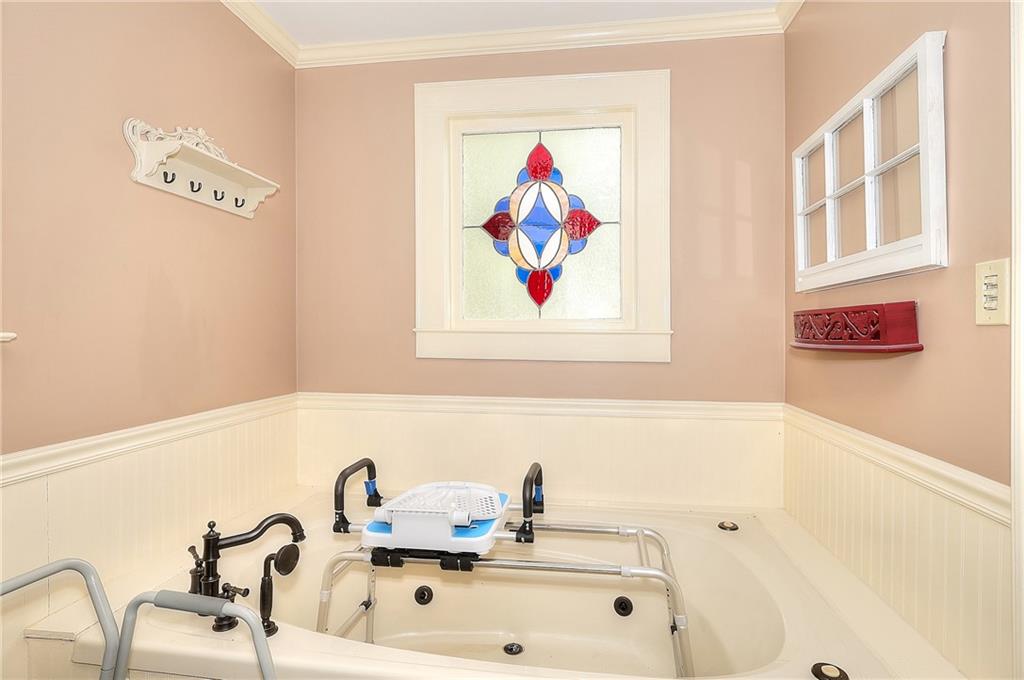 317 North Cherokee Road Social Circle, GA 30025 - Photo 20 of 32 a bathroom with a sink a mirror and a bathtub