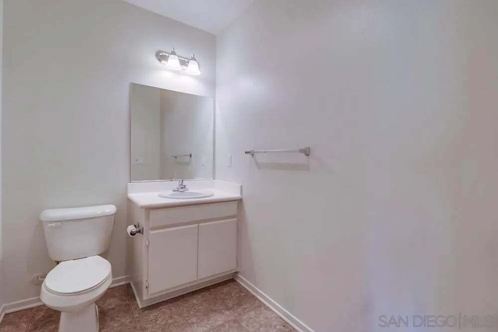 1257 Idanan Road, Unit 3 Chula Vista, CA 91913 - Photo 14 of 40 a bathroom with a toilet sink and mirror