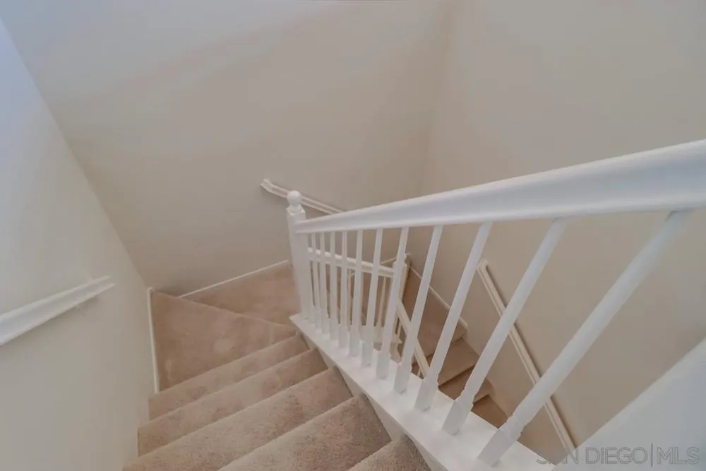 1257 Idanan Road, Unit 3 Chula Vista, CA 91913 - Photo 15 of 40 a view of staircase with white walls and white door