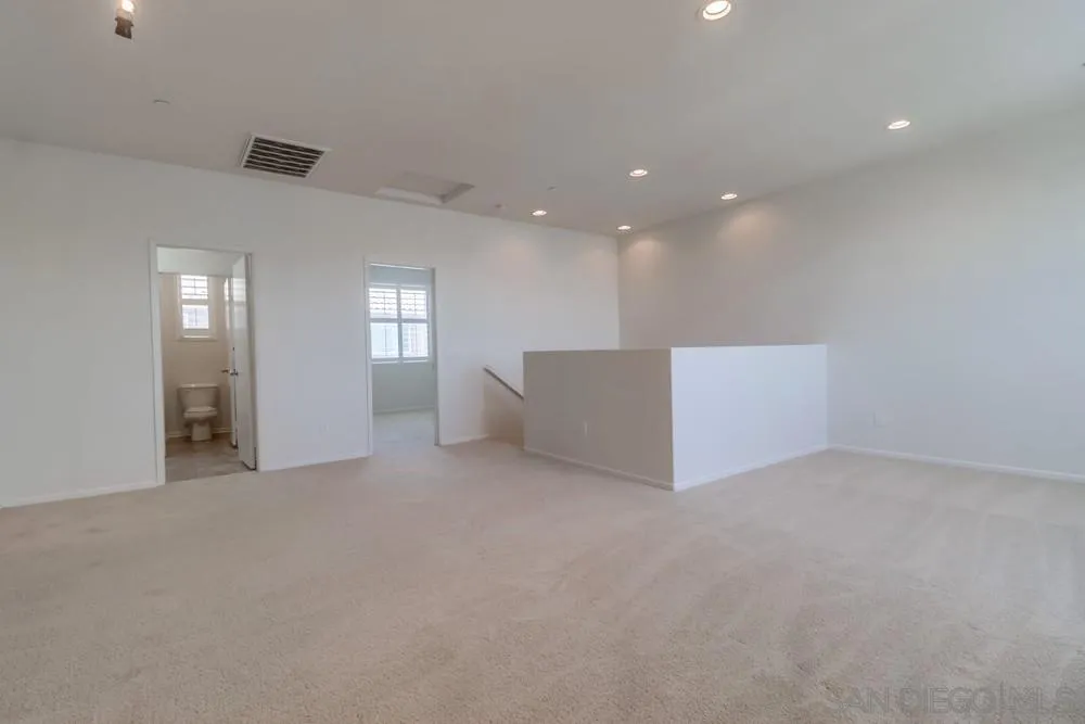 1257 Idanan Road, Unit 3 Chula Vista, CA 91913 - Photo 18 of 40 an empty room with windows and way to kitchen