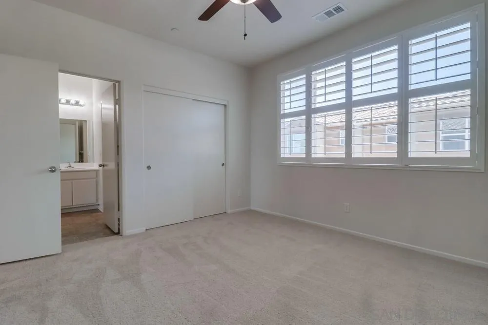 1257 Idanan Road, Unit 3 Chula Vista, CA 91913 - Photo 21 of 40 an empty room with a window and a chandelier fan