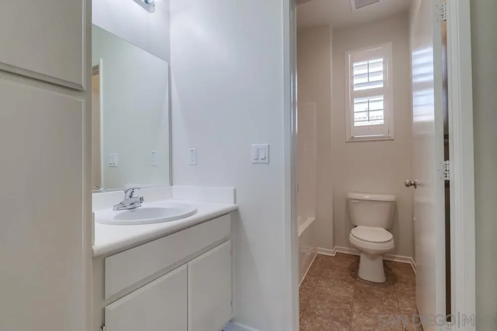 1257 Idanan Road, Unit 3 Chula Vista, CA 91913 - Photo 22 of 40 a bathroom with a sink toilet and a mirror