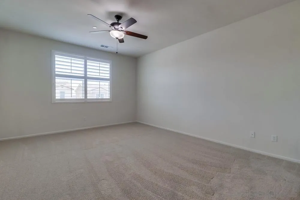 1257 Idanan Road, Unit 3 Chula Vista, CA 91913 - Photo 30 of 40 an empty room with a window and a ceiling fan